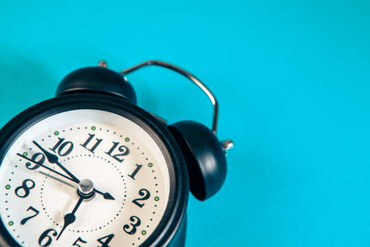  alarm clock on blue background. Time is money concept.