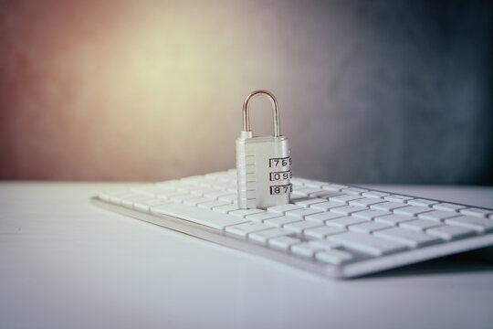 Closeup of a padlock and a laptop