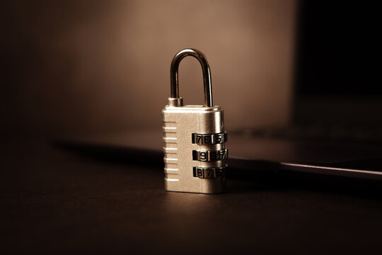 Closeup of a padlock and a laptop