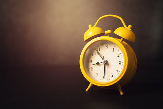 alarm clock on dark background. Copy space for text.