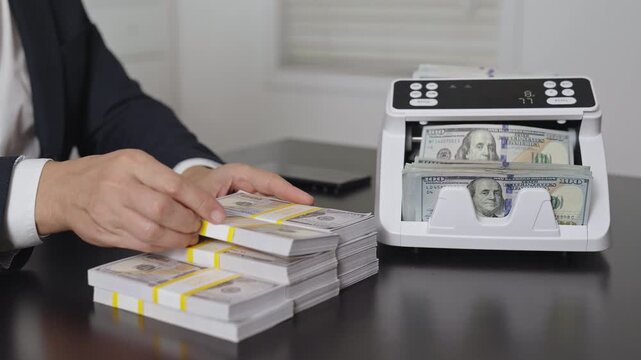 Male hand with counting money machine in office. Handling money. Businessman counting dollars close-up. Banker counting money. Business and financial growth. Banking operation in office.