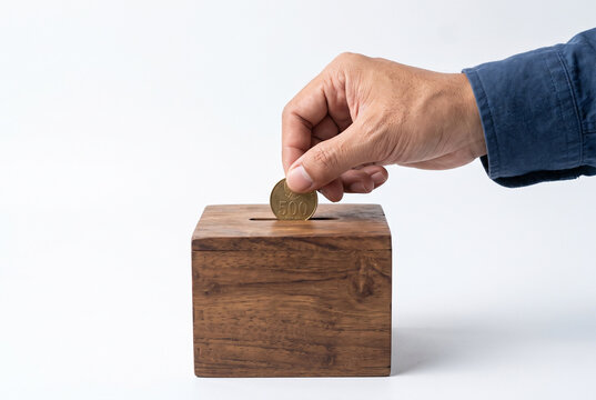 put coins in charity box, isolated on white background