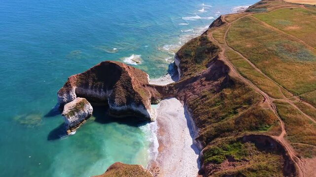 Drone shot of a dinosaur-shaped rock formation and North Sea coastline in Yorkshire, England