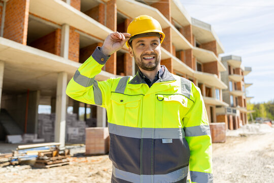 Professional male builder in yellow safety helmet posing