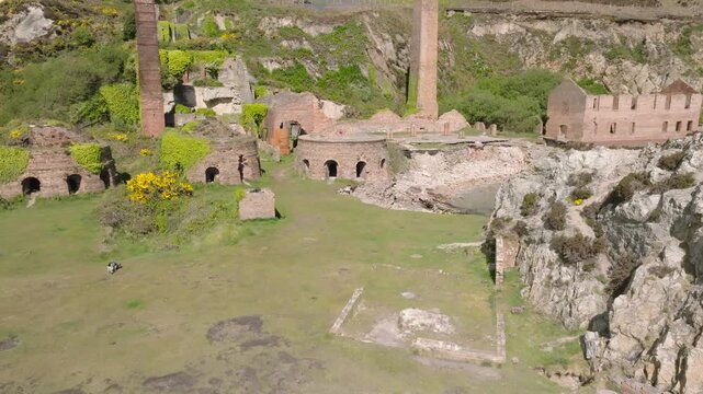 Porth Wen Brickworks, Anglesey, Wales. Slow drone rise showing beehive kilns and chimneys.
