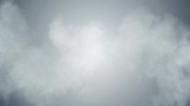 A dense layer of soft white and gray clouds drifts across the overcast sky.