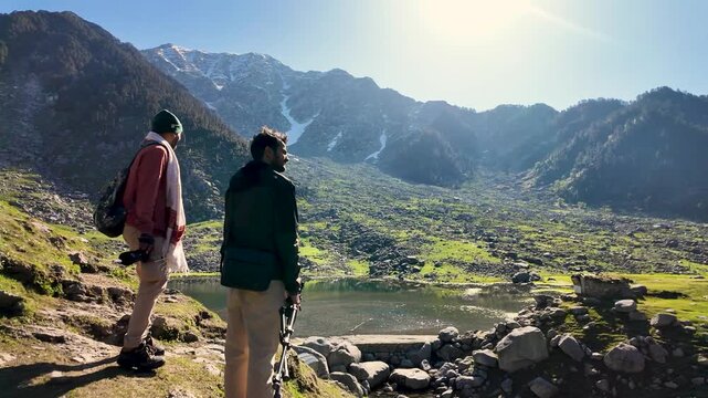 Hikers at Kareri Lake in Kangra Himachal Pradesh exploring scenic mountain landscape trails.