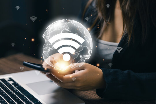 Business professional using smartphone with global WiFi network, illustrating wireless internet connectivity, mobile communication, digital technology, networking, and worldwide access.