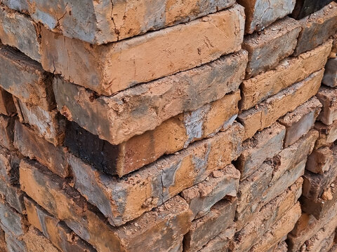 Close-up of stacked red bricks, raw building materials for masonry work