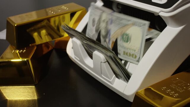 Money counting machine processing hundred dollar bills. Money count in motion. Banking operation with money and gold. Counting machine for money theme.