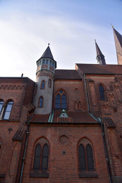 View from below of the side of St. Alban's Church, Odense, Denmark. Example of red brick neo-gothic architecture with a tower. 