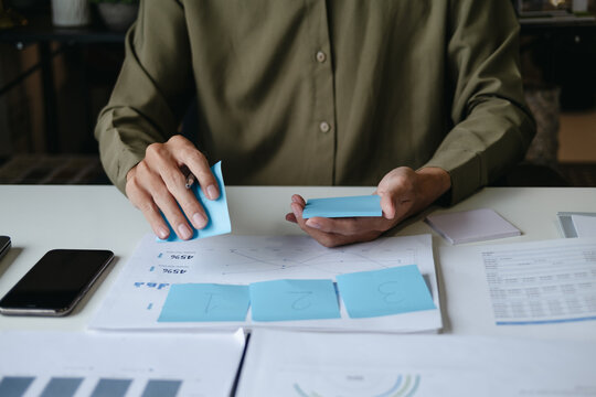 Focused accountant analyzing office documents for valuation accuracy