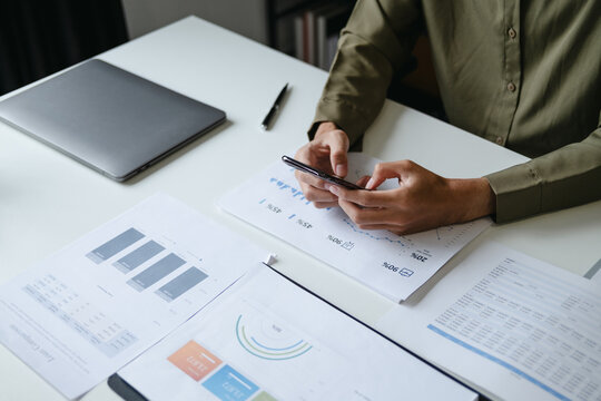 Focused accountant analyzing office documents for valuation accuracy