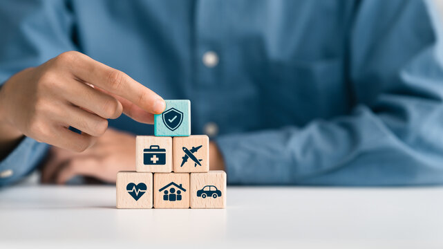 Healthcare, life and travel insurance concept on wooden cube for safety, medical and planning in Future. investment and retirement.