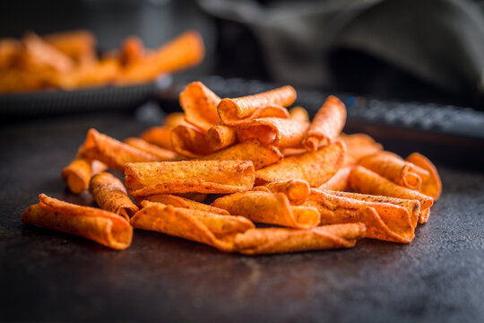 Crispy Spicy Taquitos Pile on Dark Surface Close-Up, Mexican Rolled Corn Snack