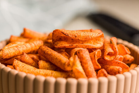 Close-Up Of Spicy Corn Snack Chips In A Bowl With Chili Seasoning And Crunchy Texture