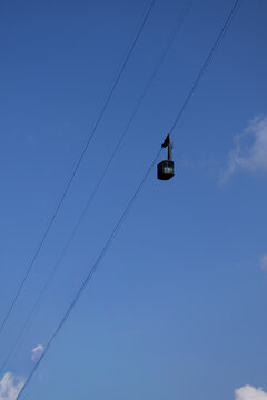 Red Cable Car Gondola Ascending Blue Sky in Bucegi Mountains Busteni Romania