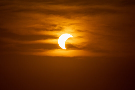 solar eclipse the moon obscures the sun sunset in the mountains