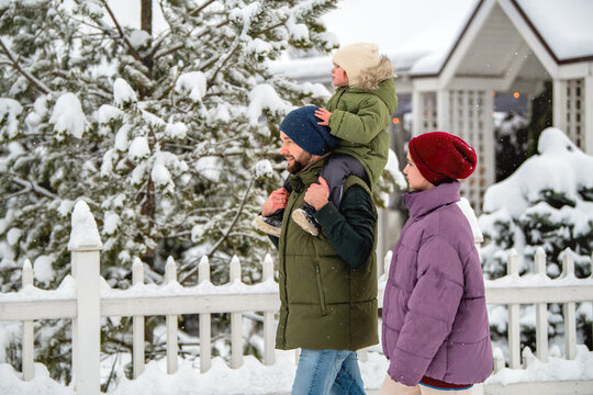 Family walking together on a snowy winter day