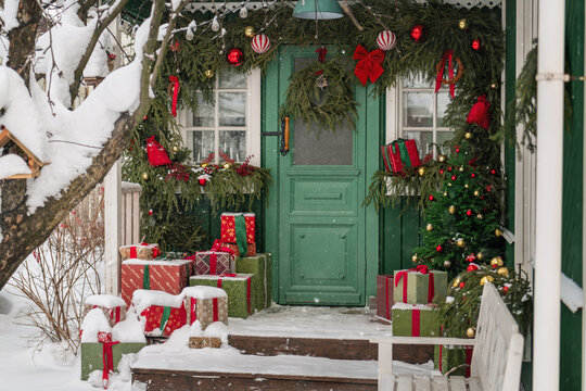 House porch decorated for Christmas in the snow