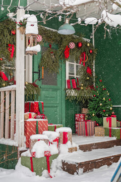 Snowy Christmas presents on a decorated porch