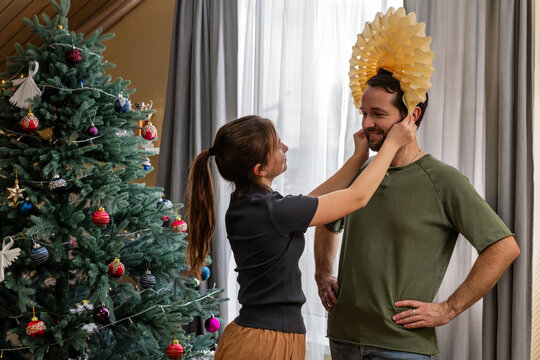 dad and his daughter are having fun with Christmas decorations.