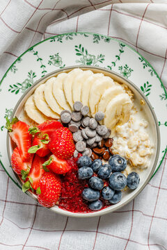Oatmeal bowl topped with fruit and chocolate chips