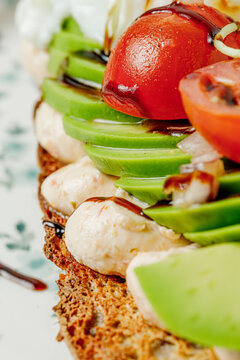 Artisan avocado toast with cherry tomatoes and glaze