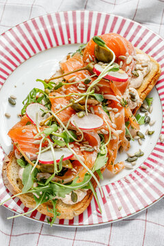 Gourmet smoked salmon toast with capers and greens