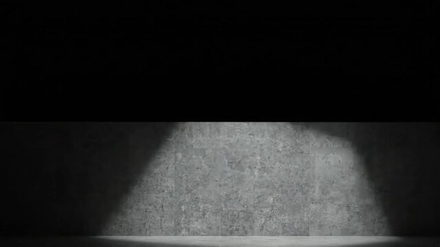 Concrete wall with shifting dramatic spotlight illumination moving across textured surface in this dark cinematic digital animation video motion clip