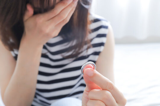 結婚指輪を外して悲しむ女性
