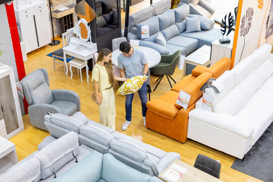 Couple shopping for furniture in a modern store