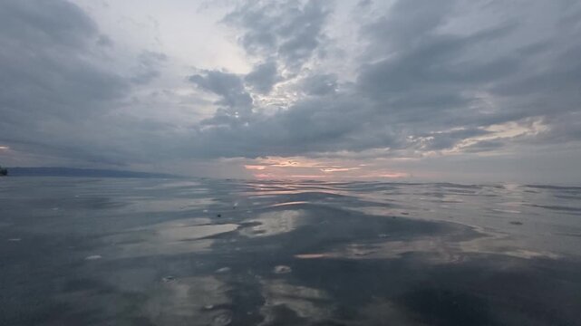 Dramatic Cloudscape Over Calm Ocean at Sunset