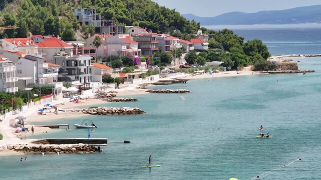 Man Paddleboarding On The Adriatic Sea Near Podstrana, Croatia