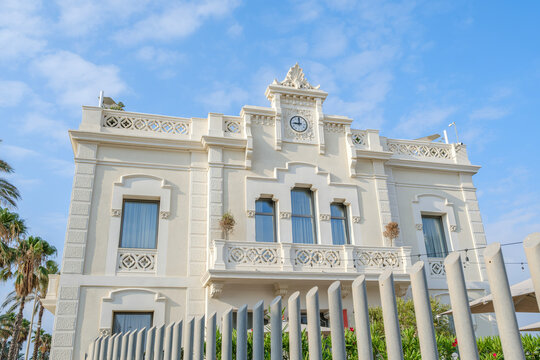 Historic Building Facade with Clock at Port Area, Barcelona, Neoclassical Architecture, Decorative Balcony, Fence