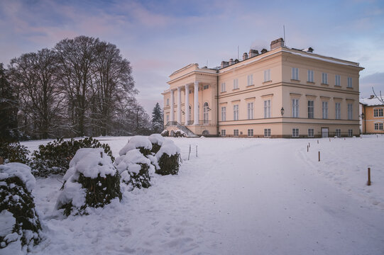 Empire style New Castle in Kostelec nad Orlic&iacute; Czech Republic surrounded by a snowy park and frosted bushes during winter season