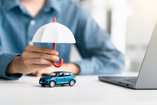 Vehicle insurance protect concept. protection and security for auto transport. Car insurance services, protection, and security. Agent Holding an umbrella automobile cover care