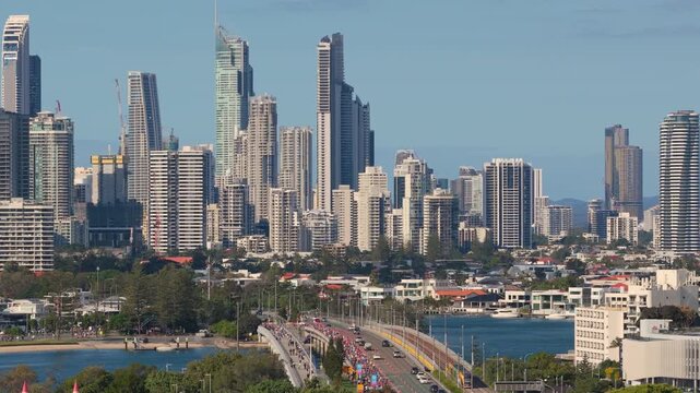 Horizontal aerial footage panning left, then pedestaling up with a slow downward tilt over Sundale Bridge, Southport and the Gold Coast Marathon, Gold Coast, Queensland, Australia