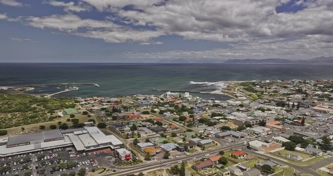 Gansbaai South Africa Aerial v21 flyover around residential neighborhoods, harbor and town center beneath coastal mountains - Shot with Mavic 3 Pro Cine - Jan 8th 2024