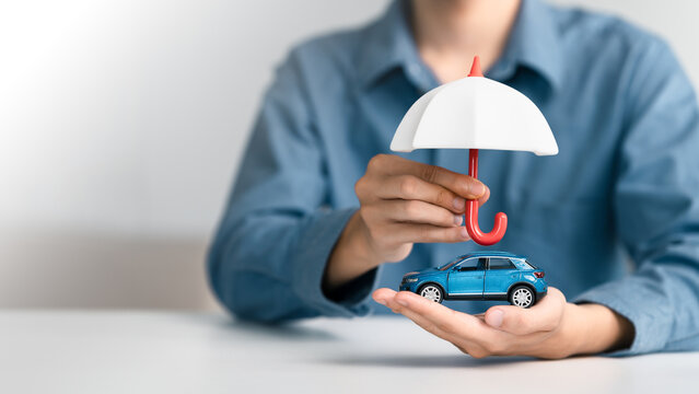 Vehicle insurance protect concept. protection and security for auto transport. Car insurance services, protection, and security. Agent Holding an umbrella automobile cover care