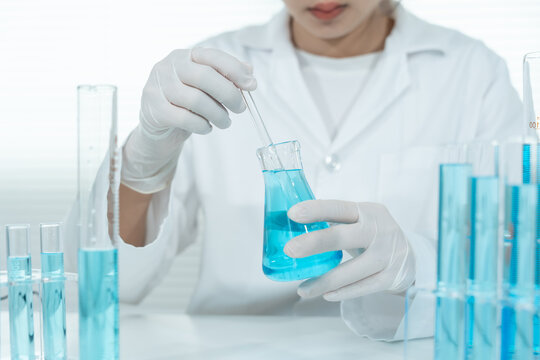Scientist analyze biochemical samples in advanced scientific laboratory. Medical professional use dropper mix microbiological developmental of viral. Biotechnology research in  science lab. cosmetic