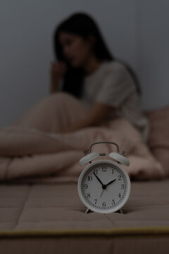 asian woman in bed late trying to sleep suffering insomnia, sleepless or scared in a nightmare, looking sad worried and stressed. Tired and headache or migraine waking up in the middle of the night.