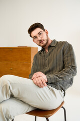 Fototapeta premium Stylish young man with beard in casual look posing confidently in studio