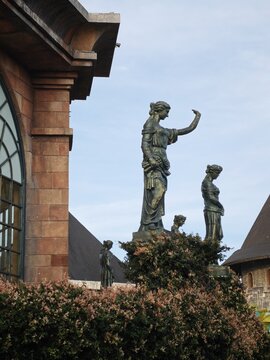 Ba Na, Da Nang, Vietnam - 01 August 2026: View of bronze statues at Ba Na Hills SunWorld surrounded by lush greenery and stone architecture under a clear blue sky.