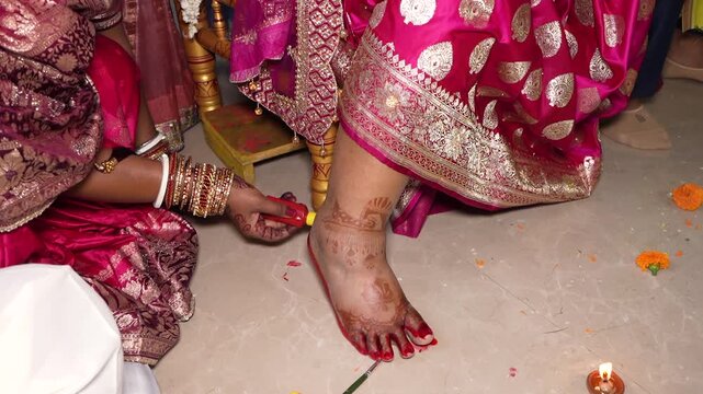 Traditional Indian Wedding Ritual Applying Alta Dye on Bride Feet in Uttarakhand India