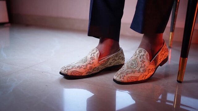 Groom wearing traditional embroidered wedding loafers in Uttarakhand India