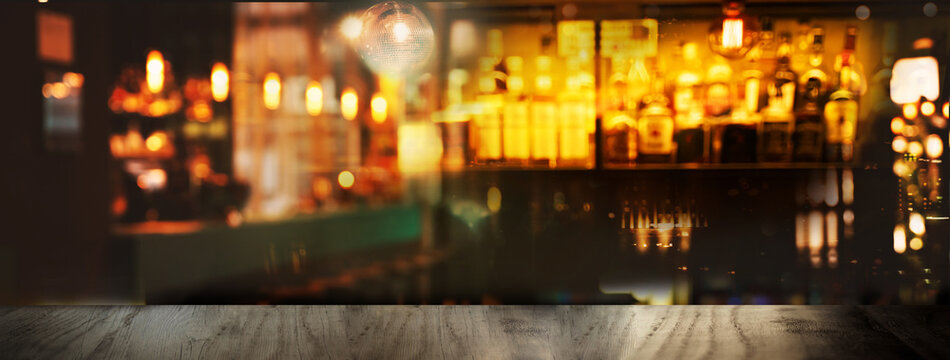 blur alcohol bottle in bar and pub with blur party light background