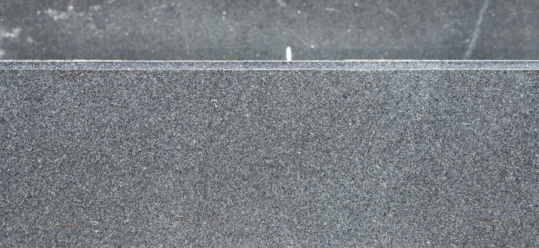 Dark grey granite stone slab edge texture background