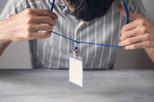 Businessman showing a plastic empty badge.