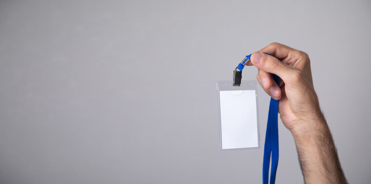 Businessman showing a plastic empty badge.